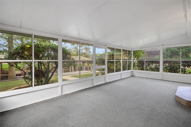 unfurnished sunroom featuring vaulted ceiling