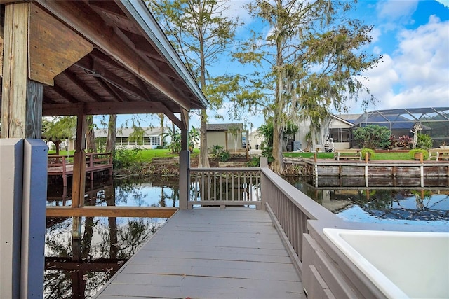 dock area featuring glass enclosure and a water view