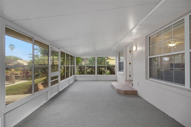 unfurnished sunroom with plenty of natural light, lofted ceiling, and ceiling fan