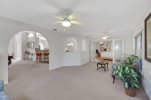 carpeted living room with ceiling fan