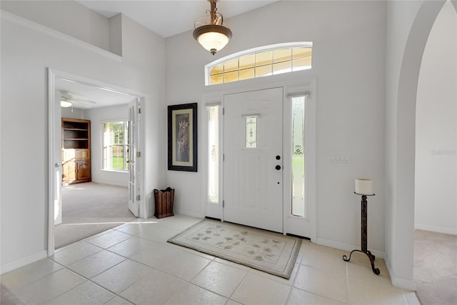 carpeted entrance foyer featuring ceiling fan