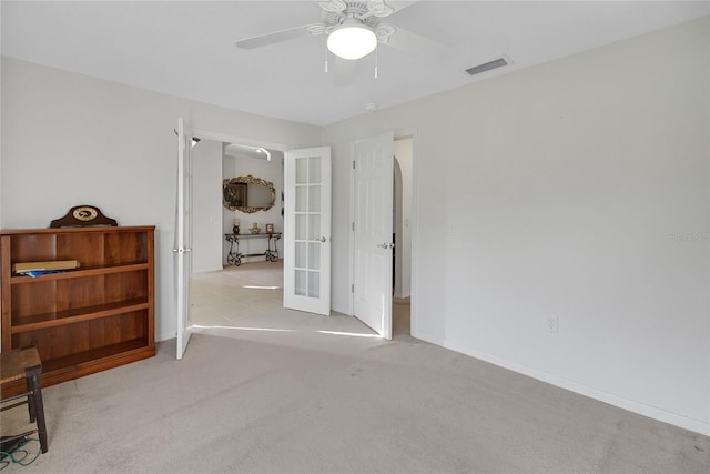 carpeted bedroom with ceiling fan and french doors