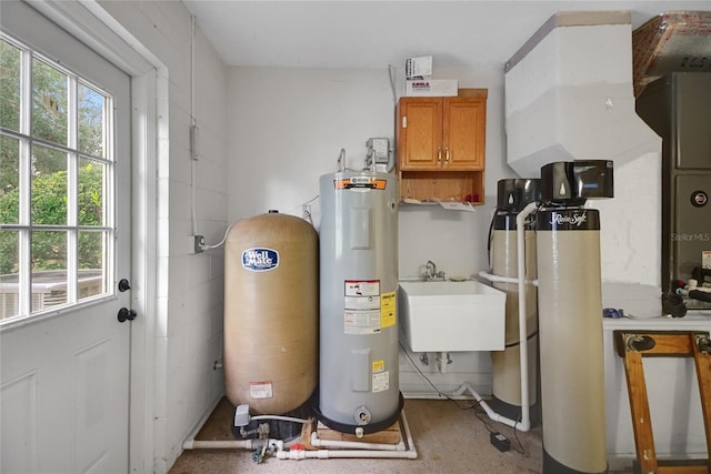 utility room featuring sink and water heater