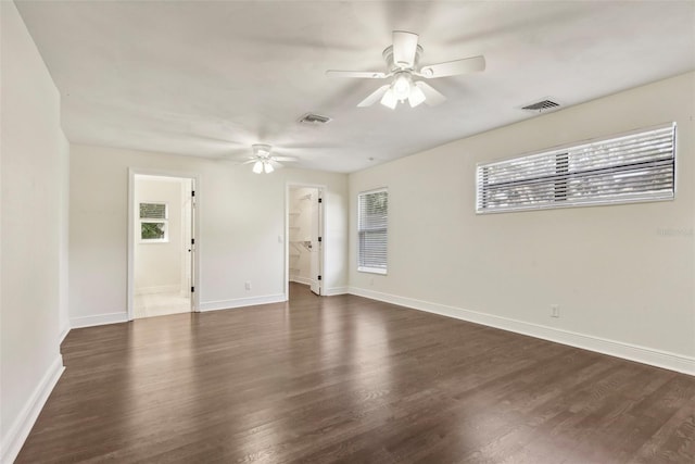 spare room featuring ceiling fan and dark hardwood / wood-style floors