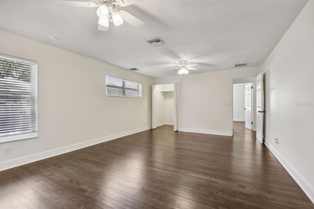 unfurnished room with ceiling fan and dark hardwood / wood-style flooring