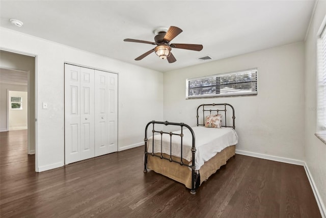 bedroom featuring a closet, ceiling fan, and dark hardwood / wood-style flooring