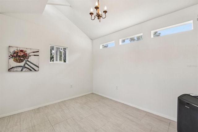 unfurnished room featuring high vaulted ceiling and a chandelier