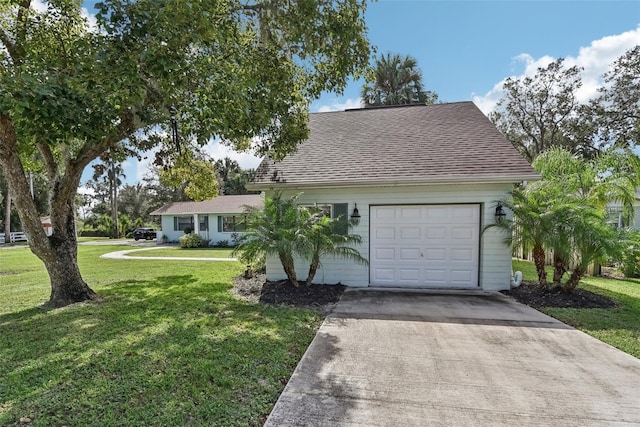 view of front of home featuring a front lawn and a garage