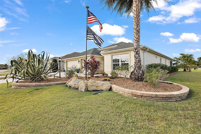 view of front of property with a front yard and a garage