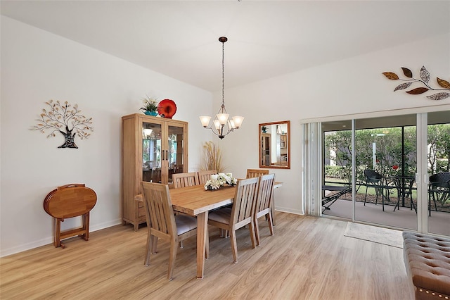 dining space featuring an inviting chandelier and light wood-type flooring