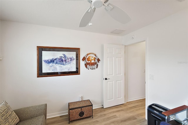 living area with ceiling fan and light hardwood / wood-style floors