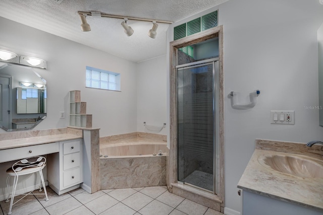 bathroom with vanity, a textured ceiling, and tile patterned floors