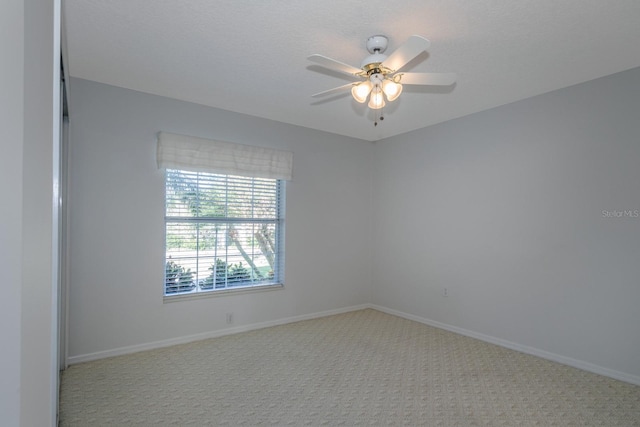 unfurnished room with ceiling fan and light carpet