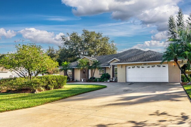 single story home with a garage and a front yard