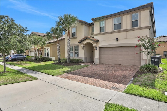 1603 Lima Ave, Kissimmee, FL 34747 - view of front of house with a garage and a front yard