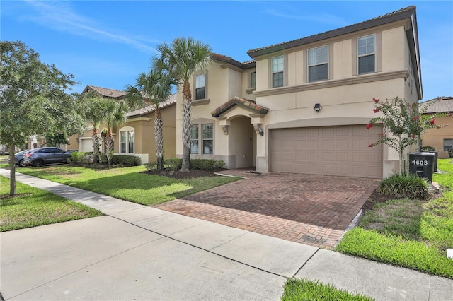 view of front of house with a garage and a front yard