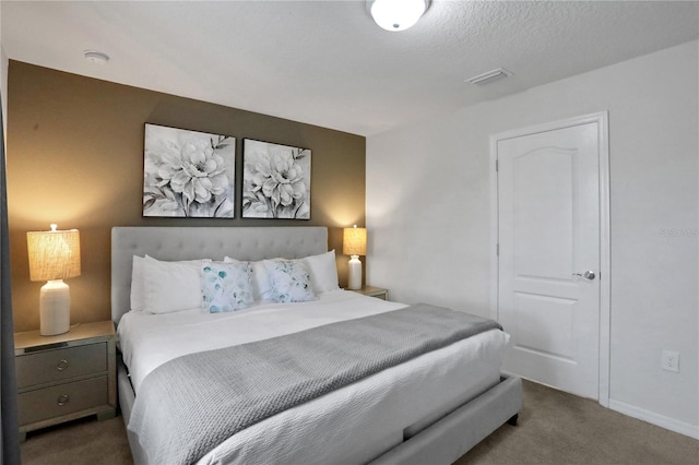 bedroom with carpet flooring and a textured ceiling