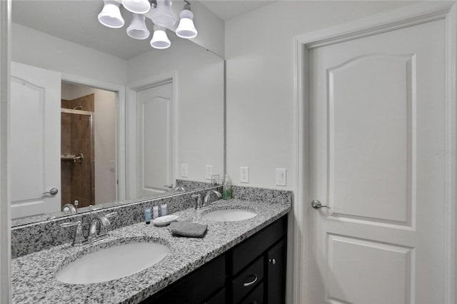 bathroom with tiled shower and vanity