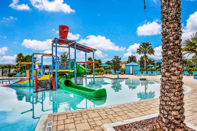 view of swimming pool featuring a playground