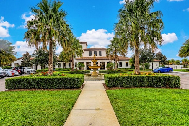 mediterranean / spanish-style house featuring a front yard