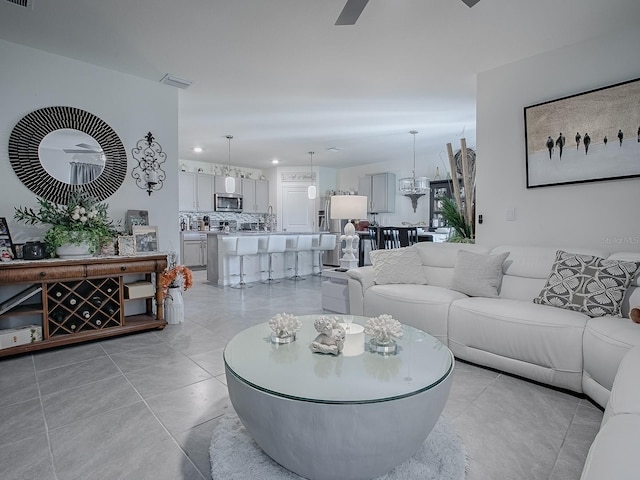 living room featuring ceiling fan and light tile patterned floors