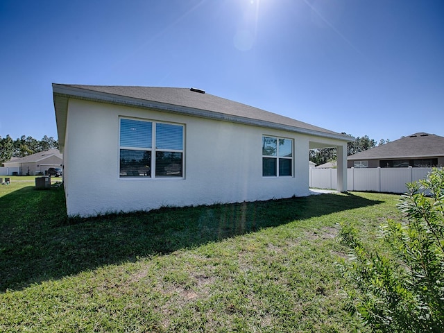 rear view of property featuring a yard