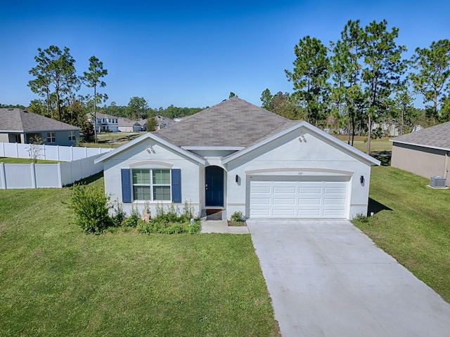 ranch-style home featuring central AC, a garage, and a front lawn