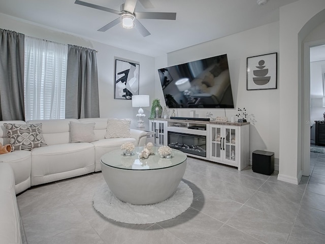 tiled living room with ceiling fan