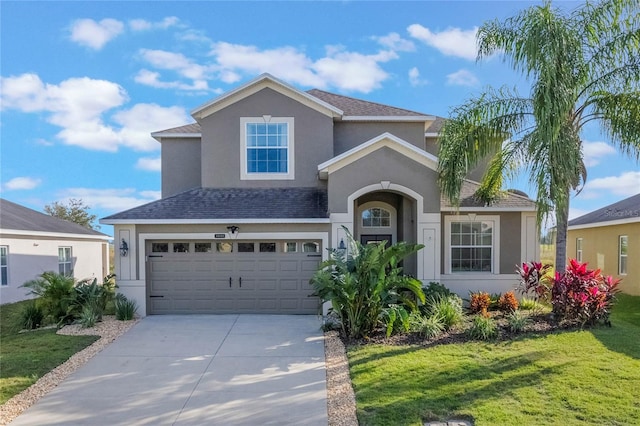 view of front facade with a garage and a front lawn