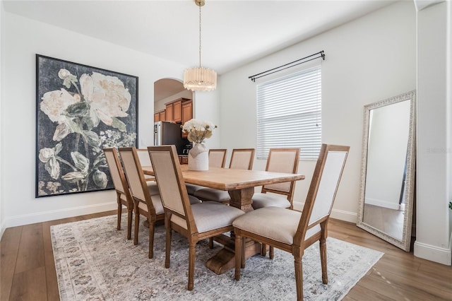 dining room featuring wood-type flooring and a notable chandelier