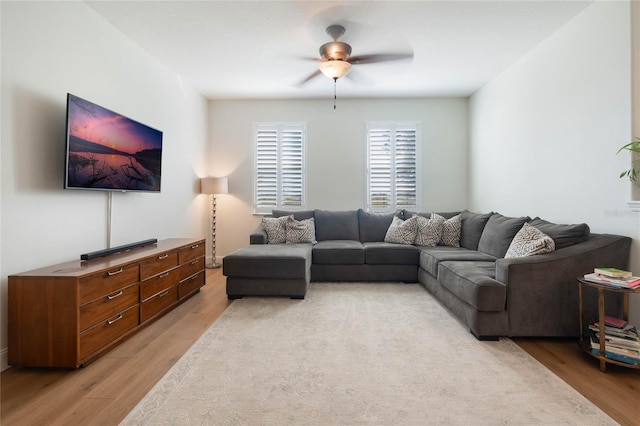 living room with ceiling fan and light hardwood / wood-style flooring