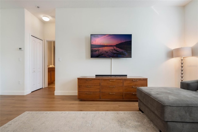 bedroom with light hardwood / wood-style floors and a closet