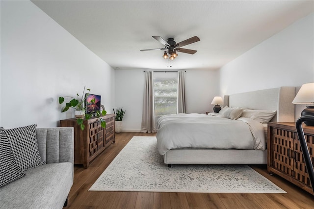 bedroom featuring ceiling fan and dark hardwood / wood-style floors