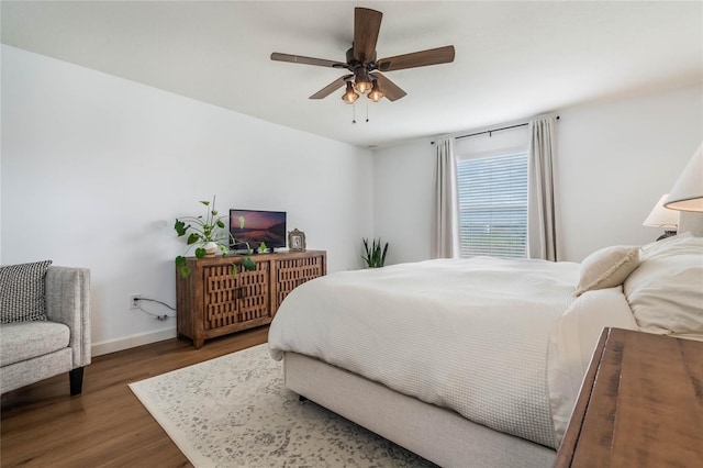 bedroom featuring ceiling fan and dark hardwood / wood-style floors