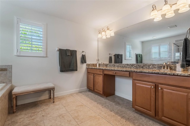 bathroom with a healthy amount of sunlight, tile patterned flooring, and vanity