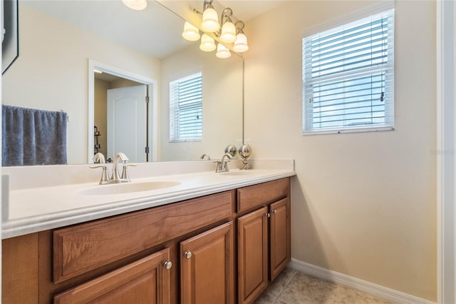 bathroom featuring vanity, tile patterned floors, and a chandelier