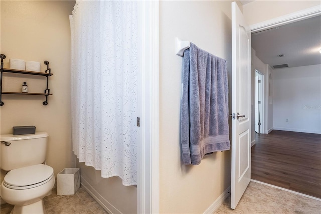 bathroom featuring toilet and tile patterned floors