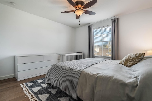 bedroom featuring ceiling fan and dark hardwood / wood-style floors