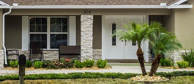 doorway to property featuring a porch