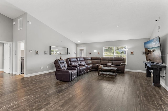 living room with high vaulted ceiling and dark wood-type flooring