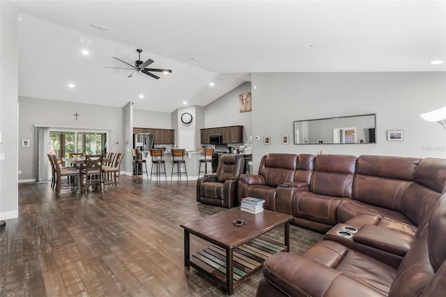 living room with dark hardwood / wood-style floors, high vaulted ceiling, and ceiling fan