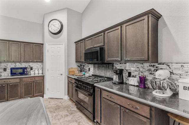 kitchen featuring high end stove, tasteful backsplash, high vaulted ceiling, and dark brown cabinetry