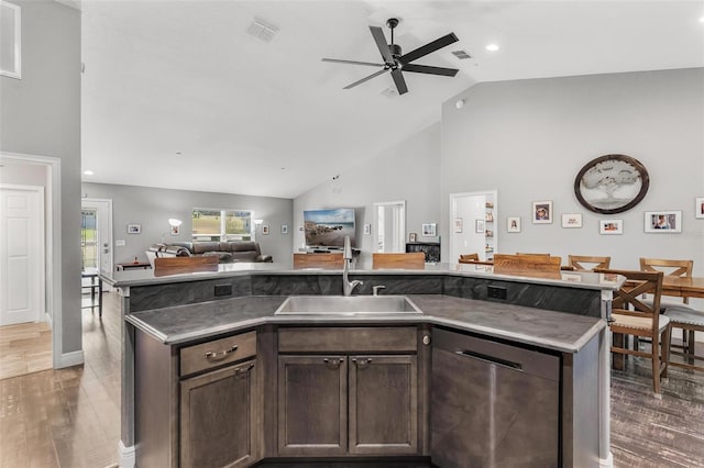 kitchen with dishwasher, dark brown cabinetry, dark wood-type flooring, and sink