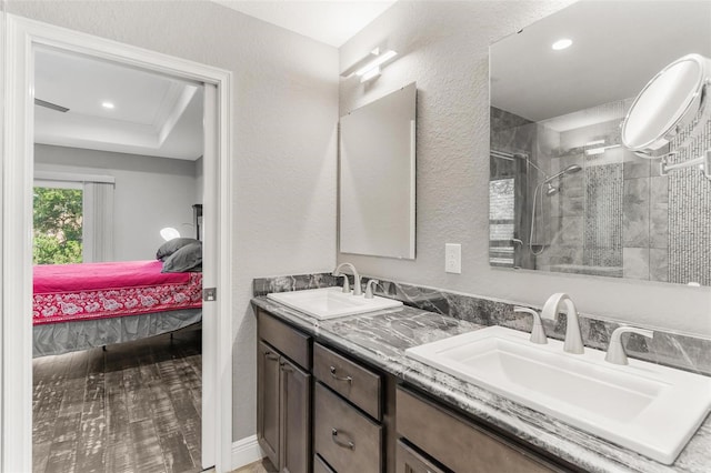 bathroom featuring vanity, wood-type flooring, and walk in shower