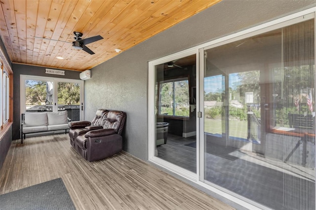 sunroom with a wall unit AC, ceiling fan, and wood ceiling