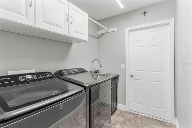 clothes washing area featuring washer and dryer, cabinets, light tile patterned floors, and sink