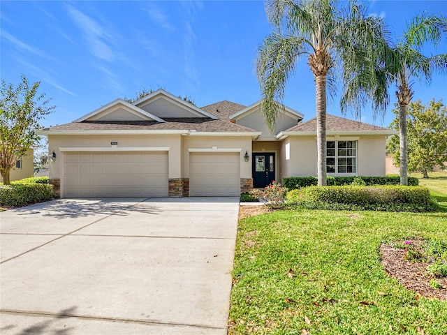 view of front of property with a front lawn and a garage