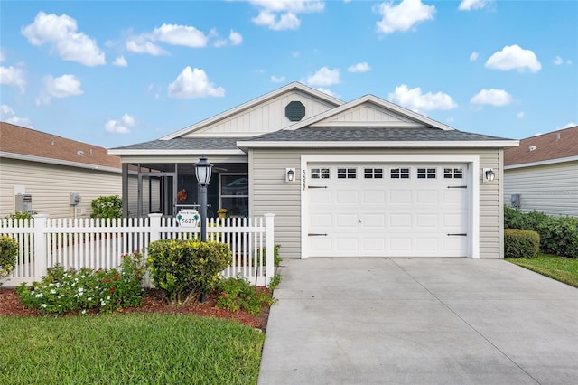 view of front of home featuring a garage and a sunroom