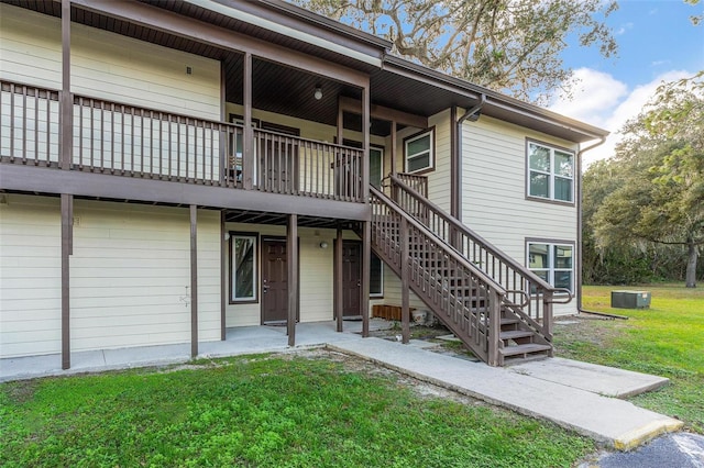 exterior space with a wooden deck and a front yard