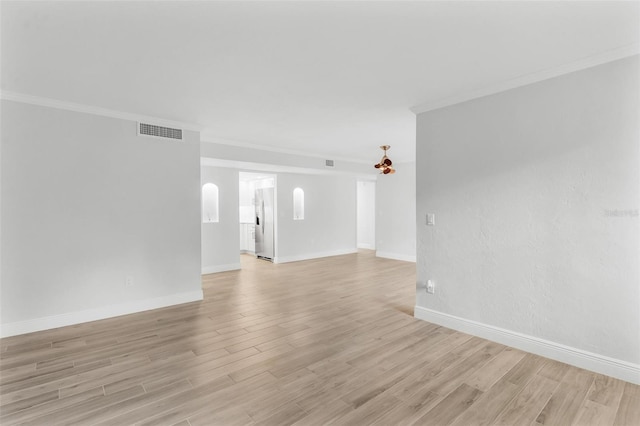 unfurnished room featuring light hardwood / wood-style flooring and ornamental molding